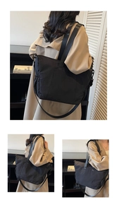 Detail of black large capacity nylon tote bag with adjustable shoulder strap for women