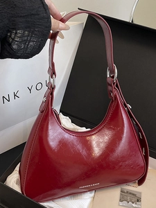 Shiny dark red hobo shoulder bag in a gift box with a sleek semi-moon crescent design