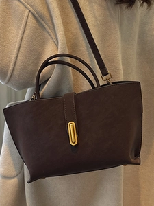 Vintage brown leather tote bag with gold oval buckle and adjustable shoulder strap