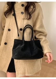 Gros plan détaillé d'un grand sac cabas en daim noir avec texture élégante et bandoulière