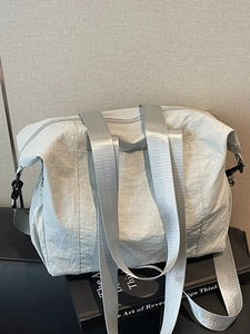 Light gray high-capacity nylon tote bag with wide webbing straps for daily commuting