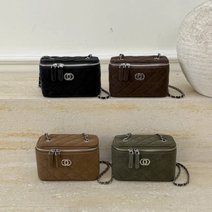 Close-up of quilted suede box bags with metal ring details and chain straps in four colors