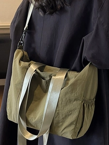 Olive green nylon tote bag with adjustable shoulder strap and large storage capacity