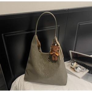 Detailed macro view of olive green faux leather tote bag with soft pleated texture
