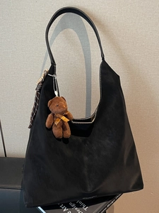 Retro black oversized crescent tote bag with teddy bear charm and plaid scarf accent