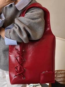 Large red hobo shoulder bag with lace-up side detail and casual oversized slouchy style