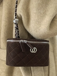 Brown quilted chain bag for women featuring a silver metal strap and vintage box style