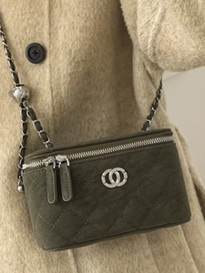 Quilted green suede camera bag with silver chain strap and metal ball adjustment