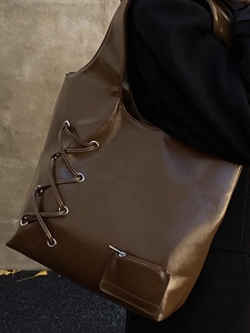 Deep brown large-capacity tote bag in glossy synthetic leather with side lace-up details