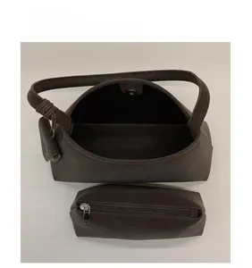 Internal view of dark brown suede shoulder bag with removable zipper pouch insert