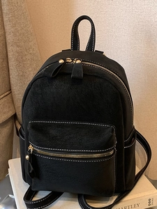 Classic black faux leather backpack with white contrast stitching and front zipper pocket
