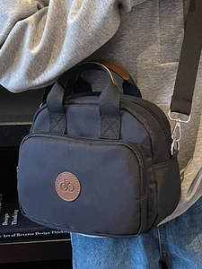 Minimalist black nylon square crossbody bag with brown leather logo patch for women