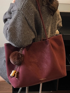 Large burgundy suede tote bag for women featuring a vintage design with plush ball charm