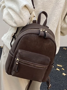 Minimalist dark brown winter backpack for women in suede and leather with gold metal accents