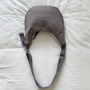Detailed top view of the taupe minimalist moon bag with wide nylon strap and zipper detail