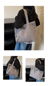 Detail view of large grey canvas tote bag with shoulder strap and hidden zipper pocket