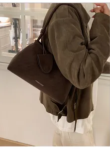 Close-up of vintage dark brown suede tote bag featuring Fashion & Bags logo print