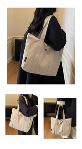Detail showing high-capacity canvas tote bag with shoulder strap and CHUANGMI brand tag