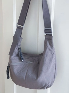 Minimalist grey-purple nylon crescent crossbody tote bag with adjustable wide shoulder strap