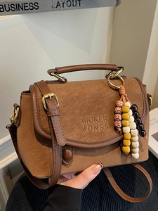 Vintage brown leather crossbody bag with aesthetic beaded tassel and top handle