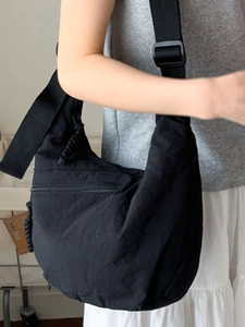 Minimalist black crescent crossbody bag with adjustable strap for daily commute and leisure