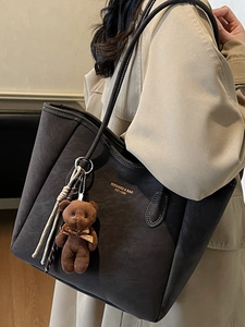 Large brown matte tote bag with shoulder straps and cute plush bear charm decoration