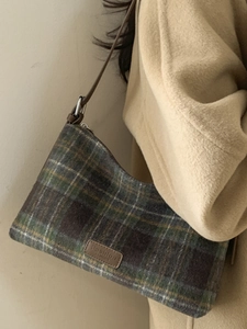 Classic plaid tote bag with brown leather straps and vintage check wool pattern