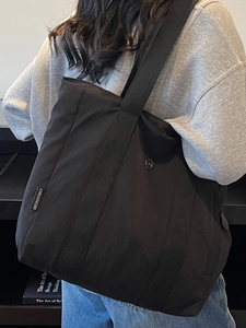 Large capacity black canvas tote bag with shoulder straps for women in casual daily style