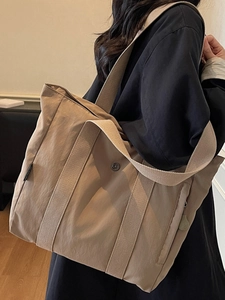 Large khaki nylon tote bag with wide handles and long shoulder strap for women
