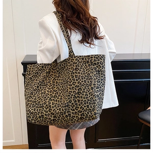 Lifestyle shot of large leopard print canvas tote bag worn with a casual outfit