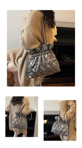 Close-up of silver quilted down shoulder bag with drawstring closure and lattice texture
