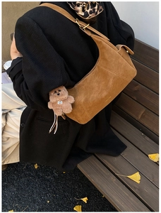 Brown faux suede hobo bag featuring a cute plush bear charm and vintage hardware detail