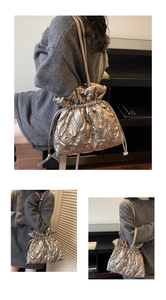 Close-up of quilted metallic drawstring bag with premium diamond stitching and slim strap