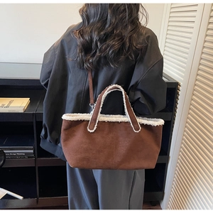 Detailed view of brown suede tote bag with white shearling trim and stylish shoulder straps