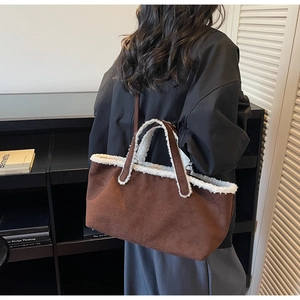 Brown suede tote bag with white faux fur trim shown in a stylish lifestyle setting