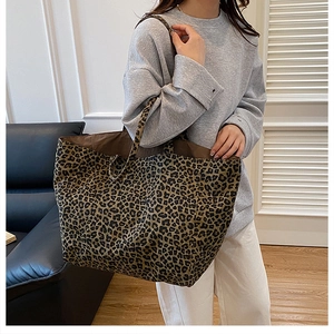 Detail of spacious leopard print canvas tote bag showing inner lining and shoulder straps