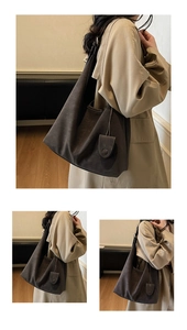 Detailed side view of dark matte leather tote bag featuring elegant pleated semi-moon design