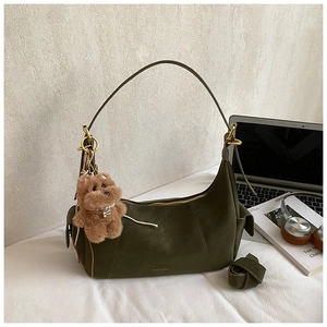 Olive green suede half-moon bag with gold zipper and cute brown plush bear pendant
