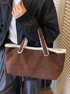 Minimalist brown suede underarm bag with white faux shearling trim and shoulder strap