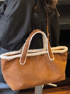 Brown faux suede underarm tote bag with white faux fur trim and adjustable strap