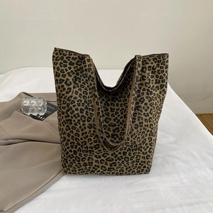 Detail of the leopard print canvas tote bag showing the thick fabric and shoulder strap