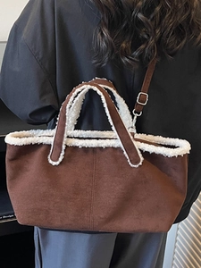 Minimalist brown suede tote bag with white faux shearling trim and long shoulder strap