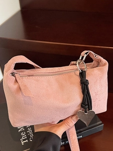 Pink suede minimalist shoulder bag with silver heart charm and black woven cord