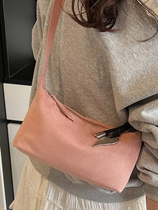 Pink suede shoulder bag with heart pendant and wide strap for women stylish winter look