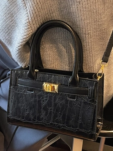 Chic black crocodile embossed crossbody bag with gold lock and adjustable shoulder strap
