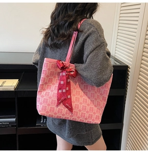 Detail of pink tote bag with red Double Happiness pattern and festive ribbon bow
