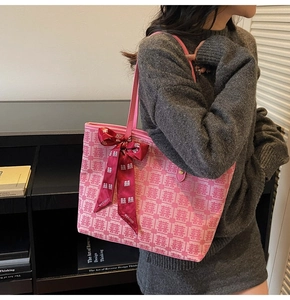 Pink tote bag detail with jacquard double happiness pattern and red ribbon bow