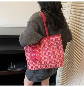 Detail of red and white knitted tote bag with festive囍 character and silk ribbon strap