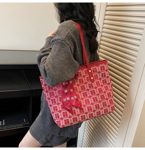 Detail of red jacquard tote bag with double happiness patterns and silk ribbon accessory