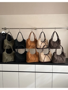 Close-up of minimalist tote bags with leather bow accents in multiple autumn colors